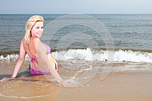 Beautiful woman in bikini sunbathing seaside