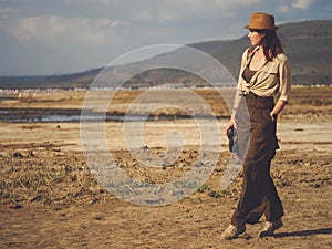 Beautiful woman with binoculars at savanna in Kenya