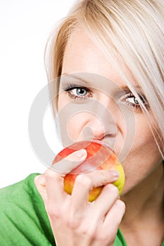 Beautiful woman biting into a fresh apple