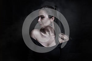 Beautiful woman on black background in studio photo