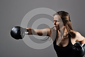 Beautiful woman with the black boxing gloves