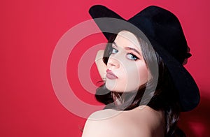 Beautiful woman in black hat. Sensual retro fashion. Isolated. High-fashion portrait.