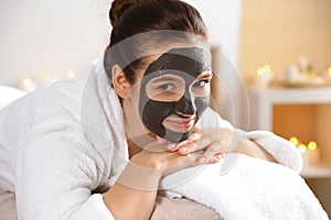 Beautiful woman with black mask on face relaxing