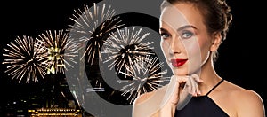 Beautiful woman in black over firework lights