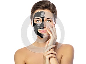 Beautiful woman with a black purifying mask on her face