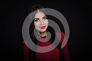 A beautiful woman with black straight hair and blue eyes in a burgundy dress