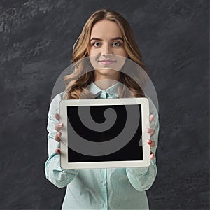 Beautiful woman with blank tablet in studio