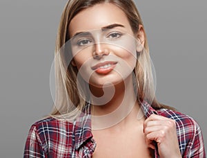 Beautiful woman blond face close up portrait young studio on gray