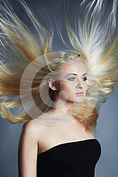 Beautiful woman. blond girl.healthy hair.Beauty salon.flying hair