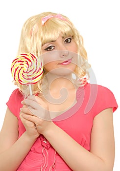 Beautiful woman in blond wig with lollipop