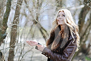 Beautiful woman in blooming tree in spring - portrait