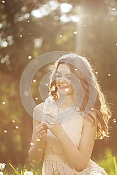 Beautiful woman blowing a dandelion