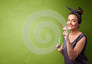 Beautiful woman blowing soap bubble on copyspace background