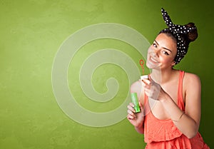 Beautiful woman blowing soap bubble on copyspace background