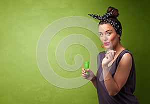 Beautiful woman blowing soap bubble on copyspace background