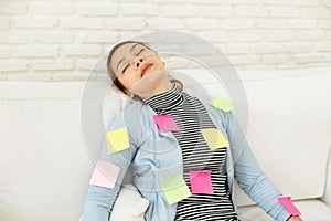 Beautiful woman in blue casual dress Sleeping on white sofa On the body filled with colorful note paper