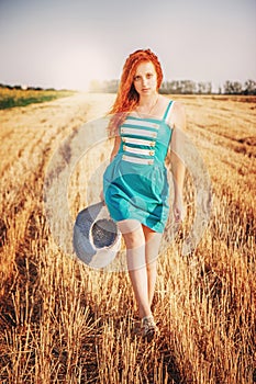 Beautiful woman in blue dress walking on the bevelled, Sun Light