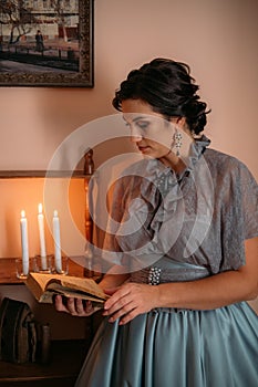 Beautiful woman in blue vintage 1800s early 1900s clothing Cottagecore Edwardian Victorian Epoque dress in old interior photo