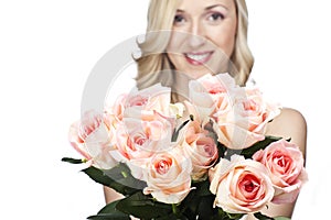 Beautiful woman with a bouquet of pink roses