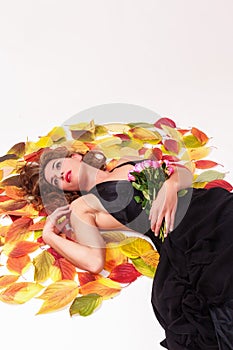 Beautiful woman with a bouquet of roses dreaming