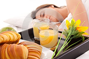 Beautiful woman with breakfast in bed