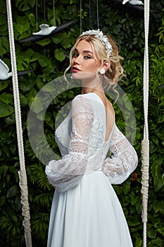 Beautiful woman bride fashion model blond hair bright makeup pretty wear long silk white dress with lace bridal ceremony wedding