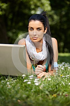 Beautiful woman browsing internet in citypark photo