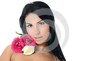 The beautiful woman brunette with bouquet of roses