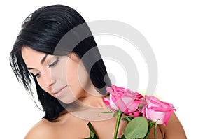 The beautiful woman brunette with bouquet of roses