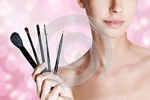 Beautiful woman with brushes for make-up