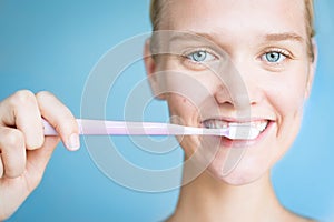 Beautiful woman brushing her teeth. Dental hygiene