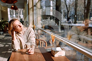 Beautiful woman in a cafe enjoying the sun