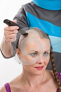 Beautiful woman cancer patient shaving hair