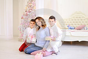 Beautiful woman and caring mother with two male children exchang