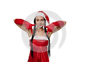 Beautiful woman in a carnival costume of Santa Claus smiling cute, looking mysteriously at camera and pointing with finger down,