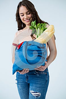 Beautiful woman carrying grocery bag