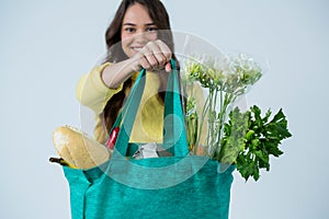 Beautiful woman carrying grocery bag