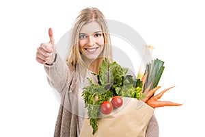 Beautiful woman carrying vegetables