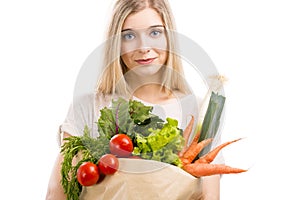 Beautiful woman carrying vegetables