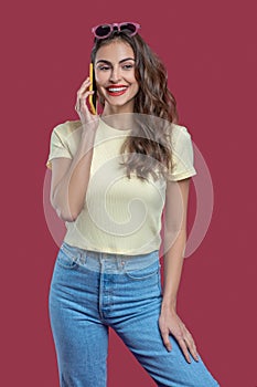 Beautiful woman in casual clothes talking on smartphone photo