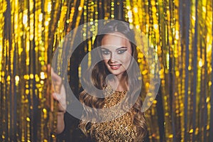 Beautiful woman celebrity with makeup on golden bokeh