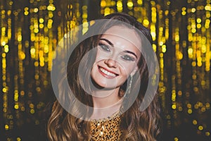 Beautiful woman celebrity with makeup on golden bokeh background.