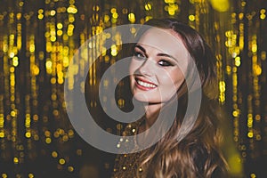 Beautiful woman celebrity with makeup on golden bokeh background.