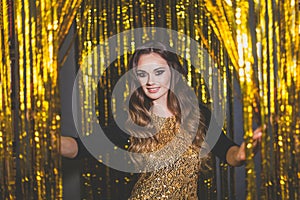 Beautiful woman celebrity with makeup on golden bokeh background.