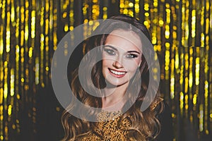 Beautiful woman celebrity with makeup on golden bokeh background.