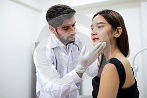Beautiful woman check skin and face with doctor before plastic surgery in the clinic. Beautician touching and looking at woman