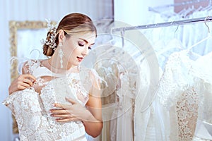 Beautiful woman chooses a wedding dress