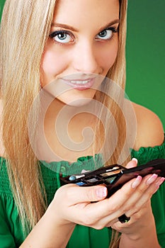 Beautiful woman choosing eyeshadow