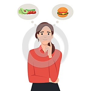 Beautiful woman choosing between salad and hamburger, healthy and junk food