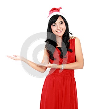 Beautiful woman in christmas santa hat showing copy space